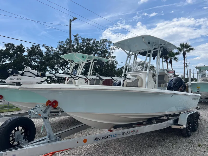 Slide: The Image of 2026 Key West 230 Bay Reef boat on trailer under blue sky. - 2