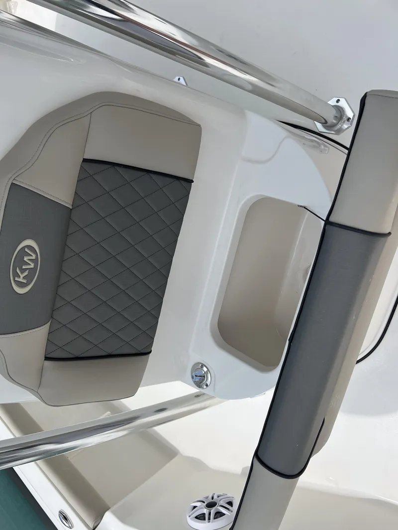 Slide: The Image of 2026 Key West 230 Bay Reef boat seat with KW logo and stainless steel railing. - 21