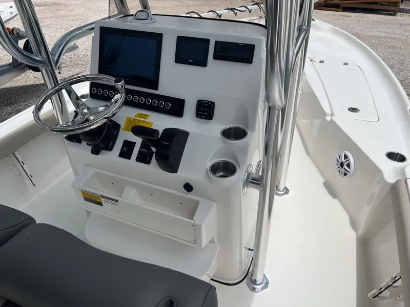 Slide: The Image of 2026 Key West 230 Bay Reef boat console with steering wheel, electronics, and cup holders. - 4