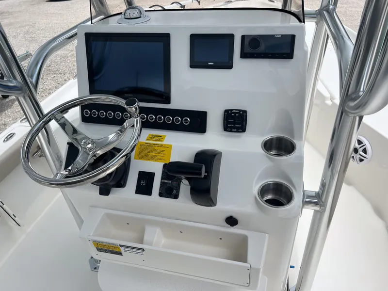 Slide: The Image of 2026 Key West 230 Bay Reef boat console with steering wheel and electronic displays. - 5