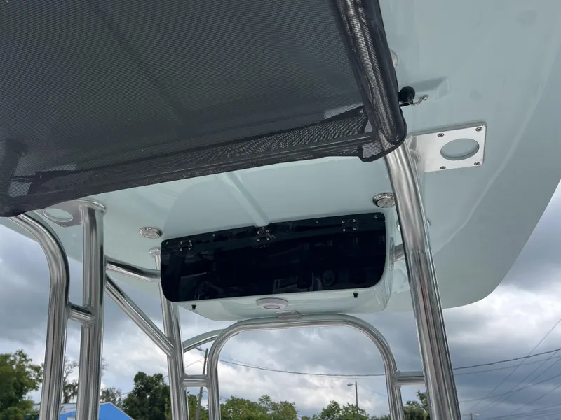 Slide: The Image of 2026 Key West 230 Bay Reef T-top with stainless steel frame and mesh canopy. - 6