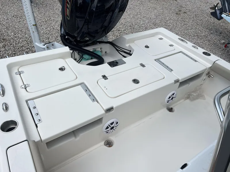 Slide: The Image of 2026 Key West 230 Bay Reef boat deck with storage compartments and speakers. - 8