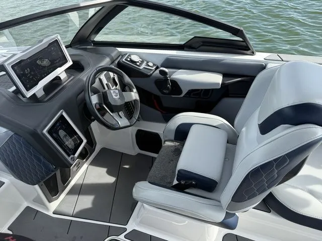 Slide: The Image of Interior of 2023 Malibu M220 boat with modern helm station. - 42