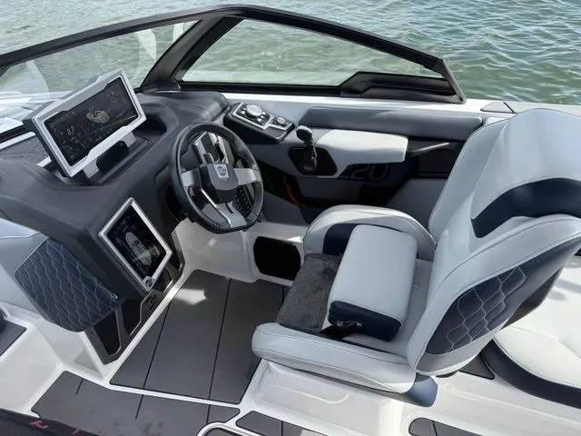 Slide: The Image of Interior of 2023 Malibu M220 boat with modern helm station. - 43