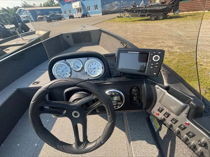 Slide: The Image of 2022 Lund 1650 Rebel XL boat dashboard with steering wheel and navigation system. - 10
