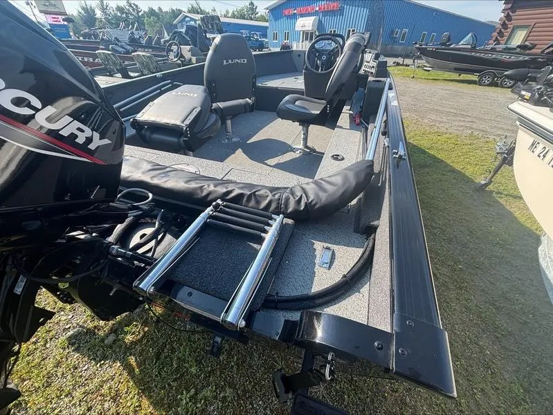 Slide: The Image of 2022 Lund 1650 Rebel XL boat interior with Mercury engine and seating. - 5