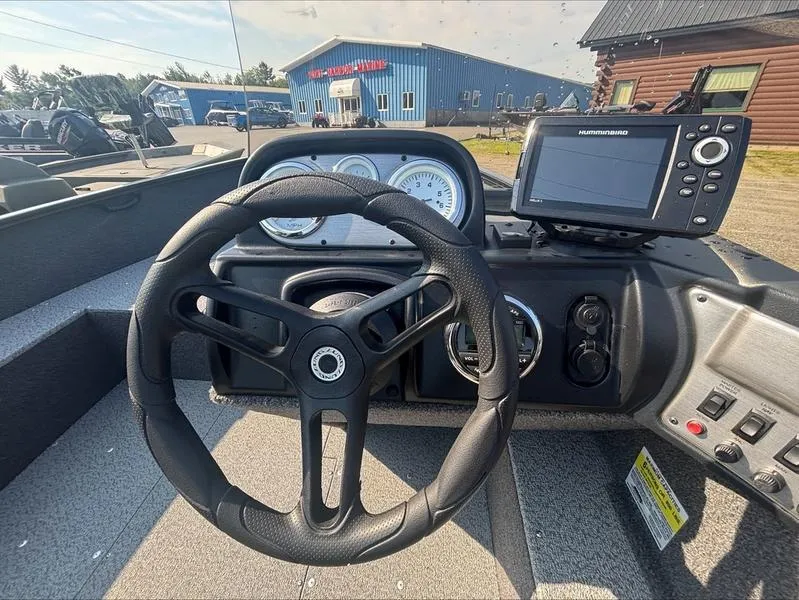 Slide: The Image of 2022 Lund 1650 Rebel XL boat dashboard with steering wheel and navigation system. - 9