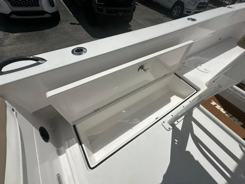 Slide: The Image of 2026 Twin Vee 22 Bay Cat boat storage compartment open, showcasing interior space. - 17