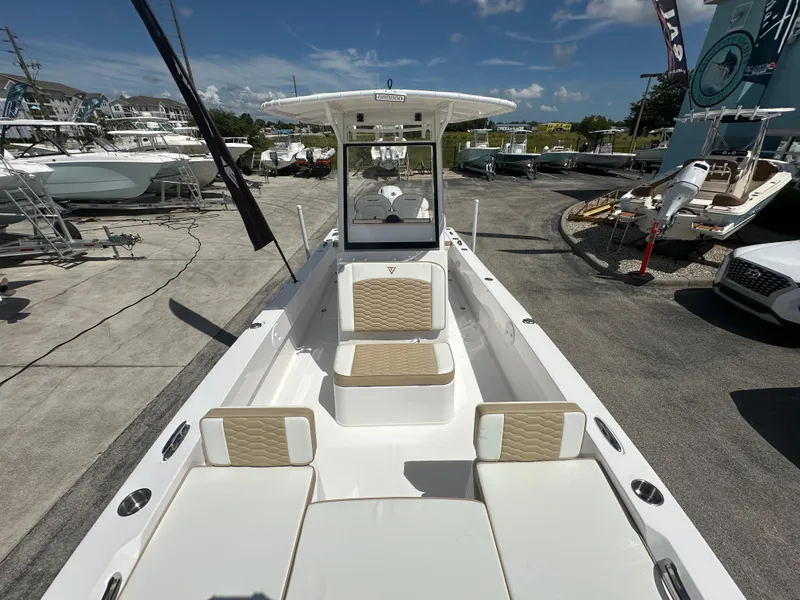 Slide: The Image of 2026 Twin Vee 22 Bay Cat boat with spacious seating, displayed outdoors under clear skies. - 7