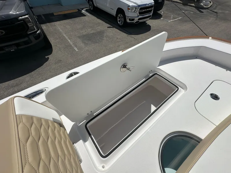 Slide: The Image of Open storage compartment on 2026 Twin Vee 22 Bay Cat boat deck. - 9