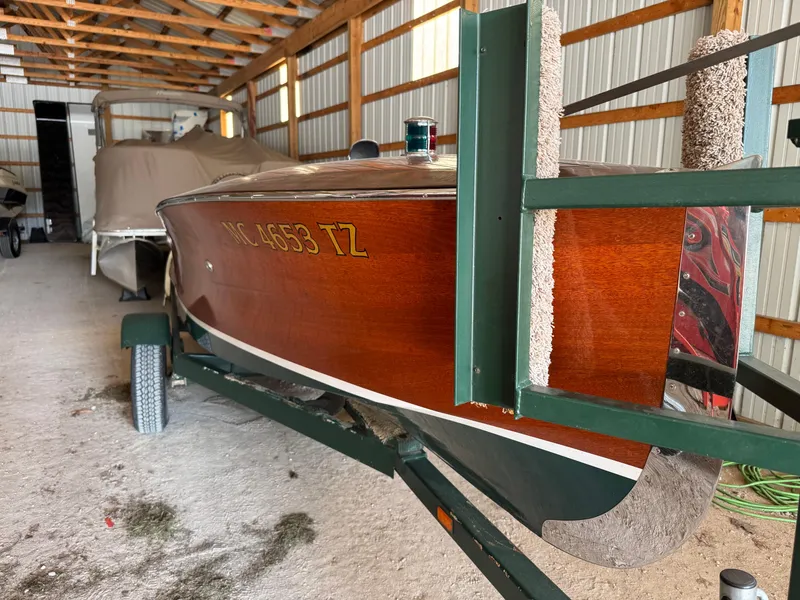 Slide: The Image of 2010 Hacker-Craft Gentleman's Racer Replica with polished wood finish on a trailer. - 2