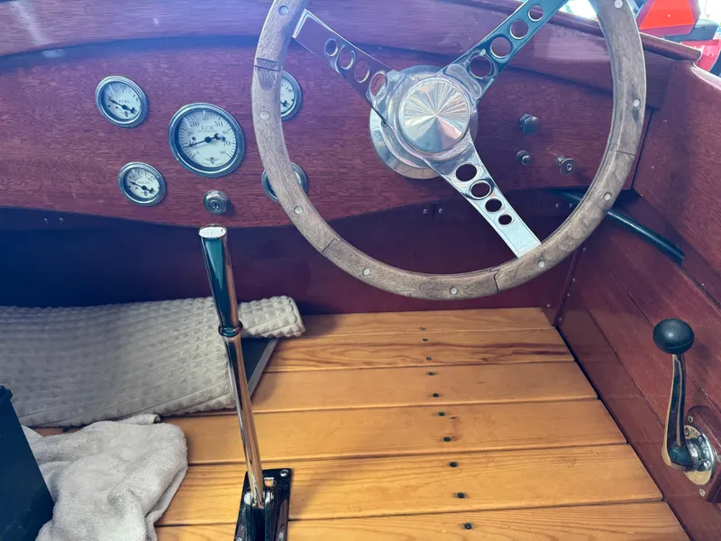 Slide: The Image of 2010 Hacker-Craft Gentleman's Racer Replica, "Bold Venture," on trailer, showcasing polished wooden finish. - 4