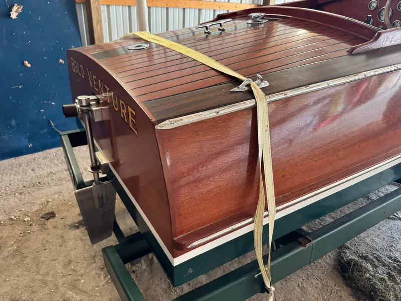 Slide: The Image of Engine compartment of a 2010 Hacker-Craft Gentleman's Racer Replica, showcasing a blue engine. - 7