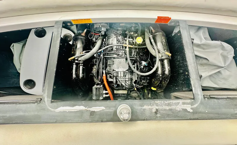 Slide: The Image of Engine compartment of a 2012 Malibu 22mxz boat, showcasing internal components. - 14