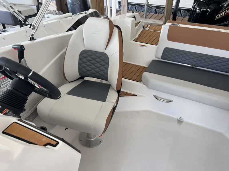 Slide: The Image of Captain's seat and helm of 2026 Starcraft SVX 231 OB boat, featuring modern design and upholstery. - 10