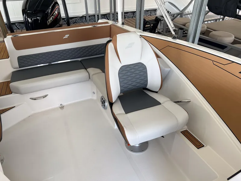 Slide: The Image of 2026 Starcraft SVX 231 OB boat interior with cushioned seating and modern design. - 11
