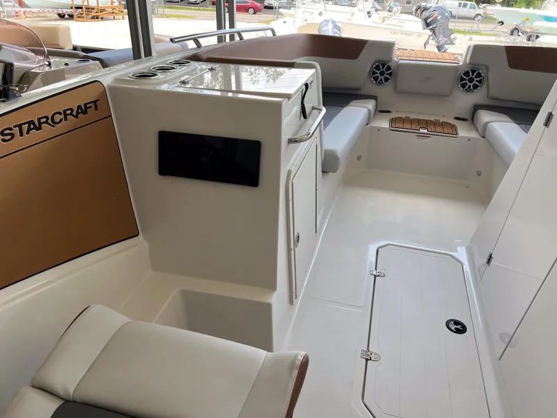 Slide: The Image of Interior of 2026 Starcraft SVX 231 OB boat, featuring seating and storage areas. - 14