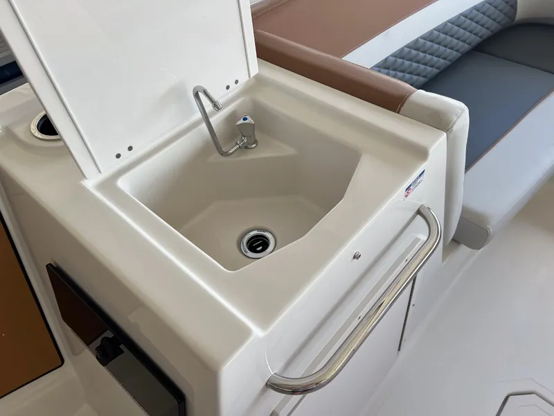 Slide: The Image of 2026 Starcraft SVX 231 OB boat interior with sink and seating area. - 16