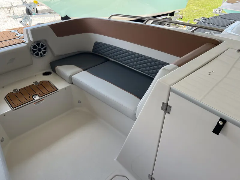 Slide: The Image of 2026 Starcraft SVX 231 OB boat interior with cushioned seating and speaker. - 17