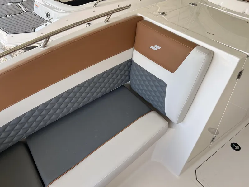 Slide: The Image of 2026 Starcraft SVX 231 OB boat interior with brown and gray cushioned seating. - 19