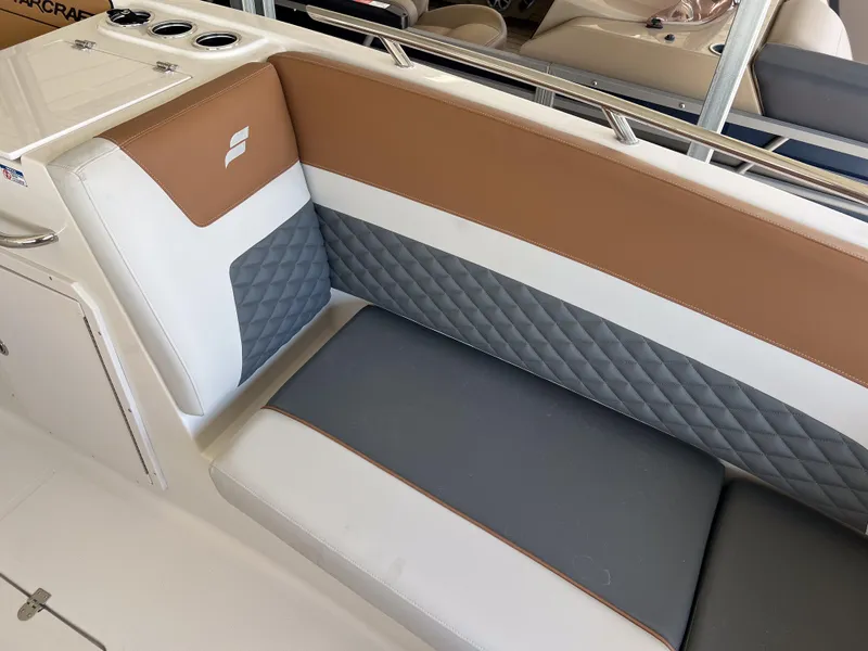 Slide: The Image of 2026 Starcraft SVX 231 OB boat interior with brown and gray cushioned seating. - 20