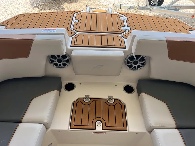 Slide: The Image of 2026 Starcraft SVX 231 OB boat interior with teak flooring and cushioned seating. - 21