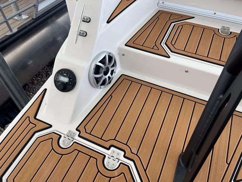 Slide: The Image of 2026 Starcraft SVX 231 OB boat deck with wood finish and speaker system. - 25