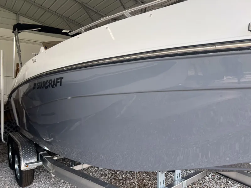Slide: The Image of 2026 Starcraft SVX 231 OB boat in storage, featuring sleek gray hull design. - 3