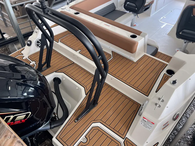 Slide: The Image of 2026 Starcraft SVX 231 OB boat interior with wood-patterned flooring and seating. - 6