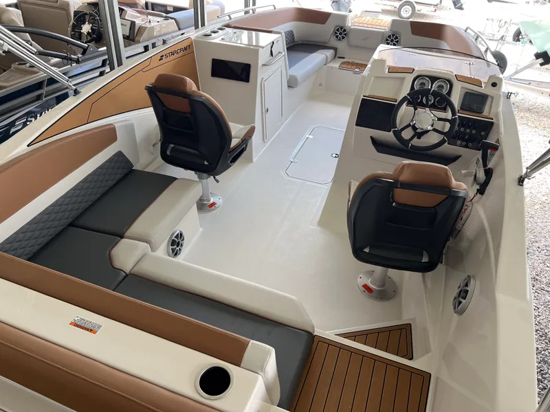 Slide: The Image of 2026 Starcraft SVX 231 OB boat interior with modern seating and steering console. - 7