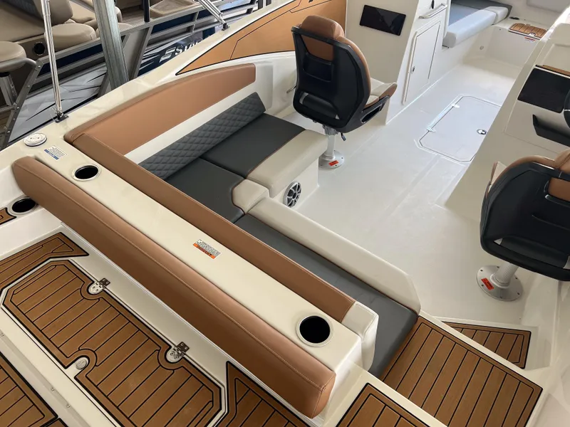 Slide: The Image of 2026 Starcraft SVX 231 OB boat interior with brown and white seating, modern design. - 8