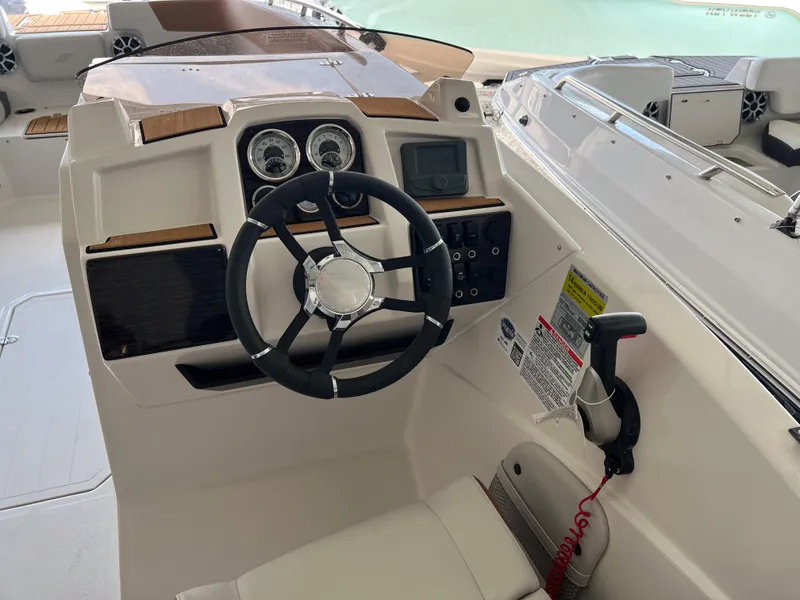Slide: The Image of 2026 Starcraft SVX 231 OB boat cockpit with steering wheel and control panel. - 9