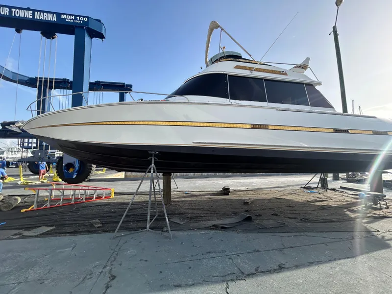 The Image of 1984 Custom 38 yacht on dry dock at marina for maintenance. - 0