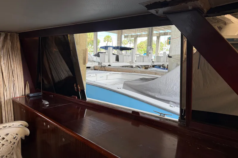 Slide: The Image of Interior view of 1984 Custom 38 boat with marina backdrop. - 10