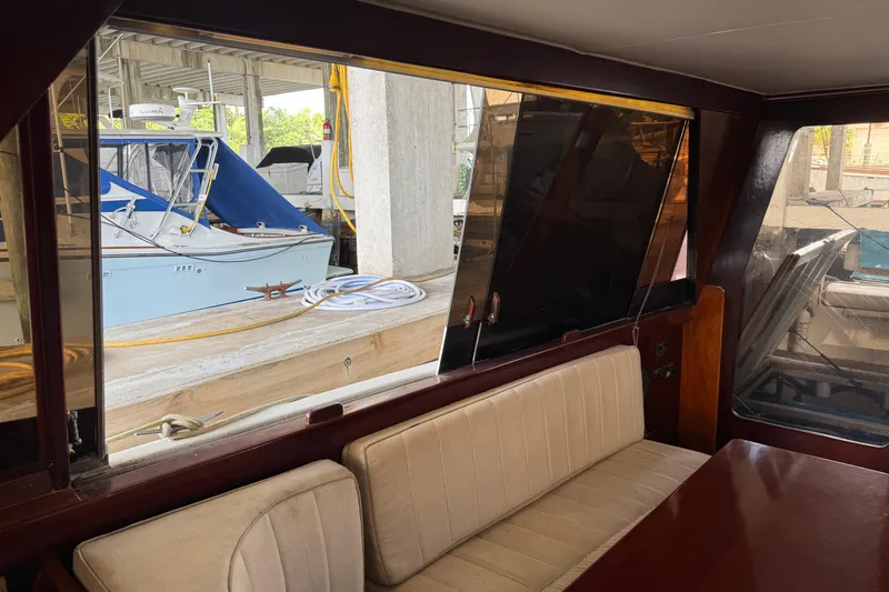 Slide: The Image of Interior view of a 1984 Custom 38 boat with docked vessels outside. - 11