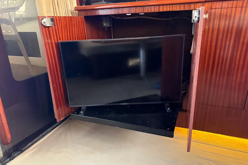 Slide: The Image of Flat-screen TV in wooden cabinet on a 1984 Custom 38 boat. - 15