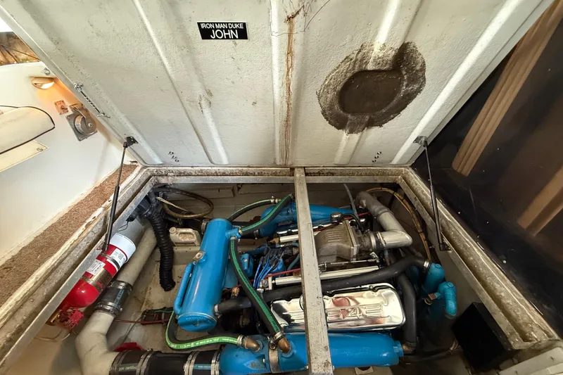 Slide: The Image of 1984 Custom 38 engine compartment with blue components and fire extinguisher. - 20