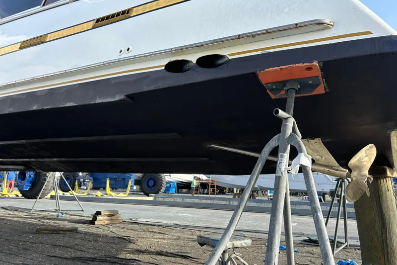 Slide: The Image of 1984 Custom 38 boat on dry dock, showing hull and propeller details. - 23