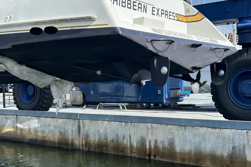 Slide: The Image of 1984 Custom 38 boat on dry dock, showcasing propeller and hull details. - 26