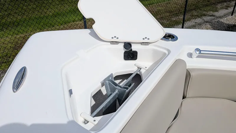 Slide: The Image of Open anchor compartment on 2026 Key West 219 FS boat, featuring sleek design and storage. - 17