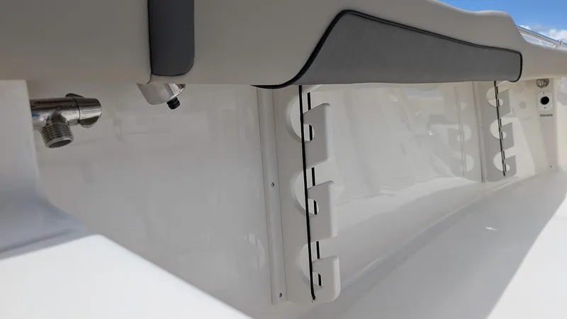 Slide: The Image of 2026 Key West 219 FS boat interior detail with rod holders and sleek design. - 19