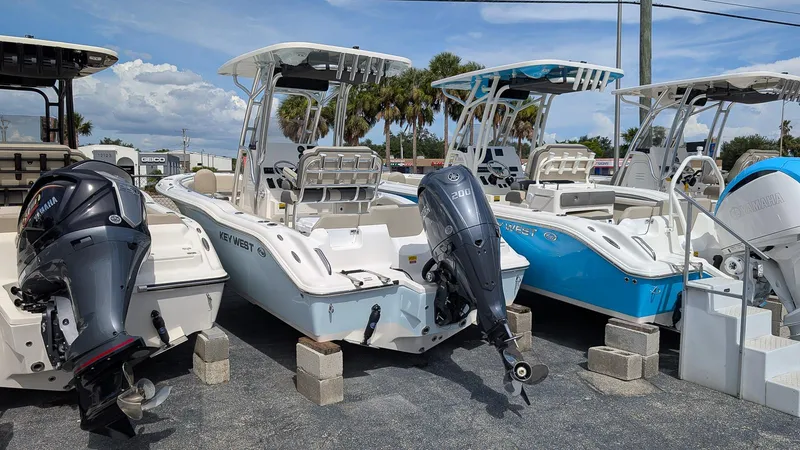 Slide: The Image of 2026 Key West 219 FS boats displayed with Yamaha outboard motors in a dealership lot. - 2
