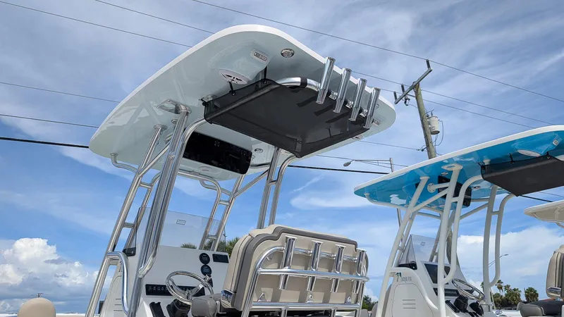 Slide: The Image of 2026 Key West 219 FS boat with T-top and rod holders under a clear sky. - 20