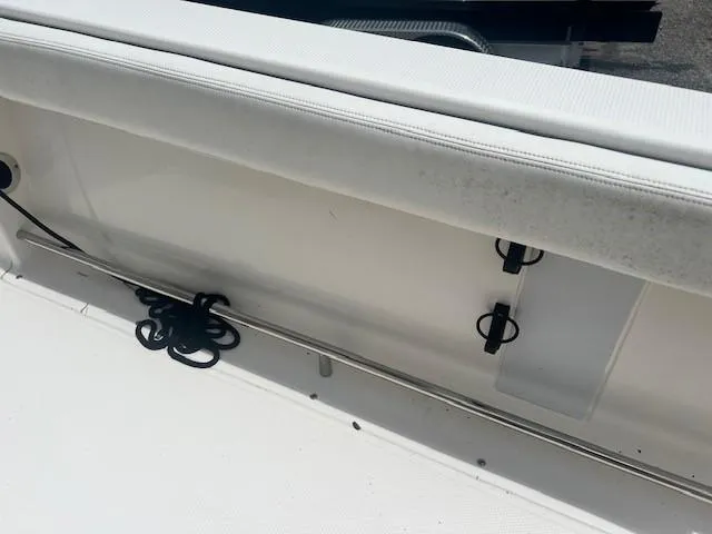 Slide: The Image of 2022 Robalo R222 Center Console boat interior with white seating and storage features. - 11