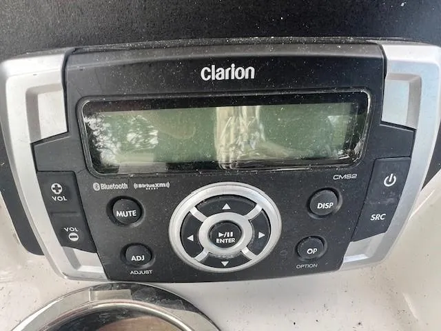 Slide: The Image of Clarion audio system on 2022 Robalo R222 Center Console boat dashboard. - 13