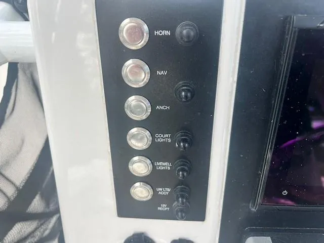 Slide: The Image of Control panel of 2022 Robalo R222 Center Console boat with labeled switches. - 14
