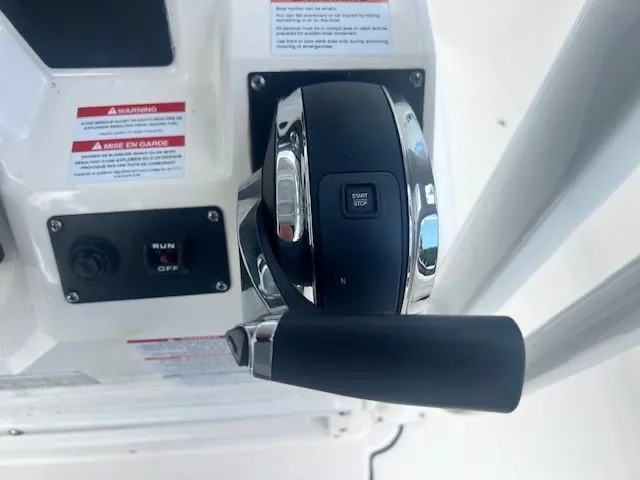 Slide: The Image of Throttle control of 2022 Robalo R222 Center Console boat with start/stop button. - 16