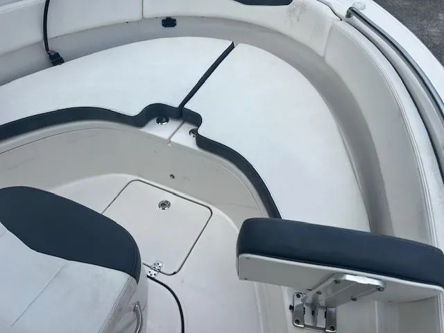 Slide: The Image of 2022 Robalo R222 Center Console boat interior with seating and storage. - 18