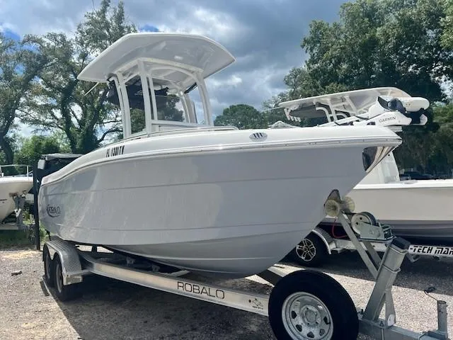 Slide: The Image of 2022 Robalo R222 Center Console boat on trailer, parked outdoors. - 2