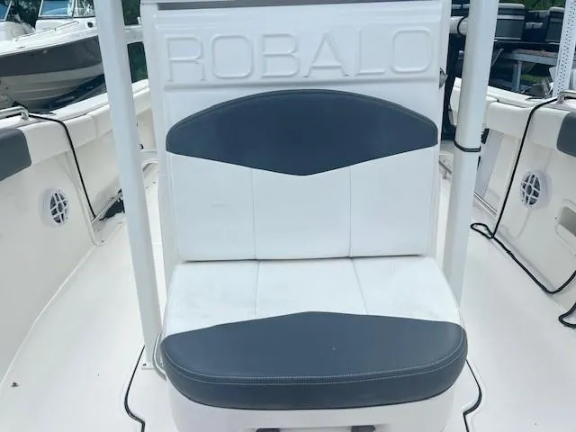 Slide: The Image of 2022 Robalo R222 Center Console boat seat with gray and white upholstery. - 20